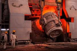 Workers supervise the steel-making process. (Image: Adobe Stock)